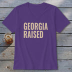 Purple V-neck t-shirt with "GEORGIA RAISED" text in tan.