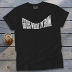 Black t-shirt with white text "GUESS WHERE I'M FROM" in a curved font.