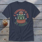 A navy t-shirt featuring a green, red, and white knit winter hat graphic with text.