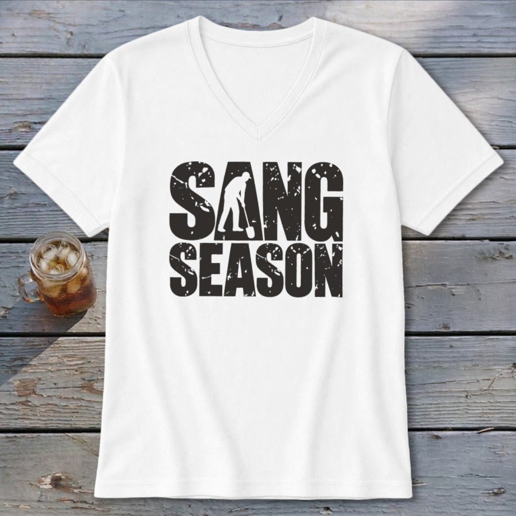 A white V-neck t-shirt featuring the distressed black text "SANG SEASON" and a graphic of a person digging.