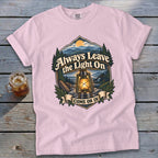 Pink t-shirt with "Always Leave the Light On Come On In" graphic and lantern.