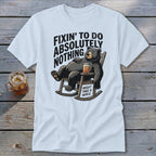 White t-shirt featuring a cartoon bear relaxing in a rocking chair with the text Fixin to Do Absolutely Nothing.