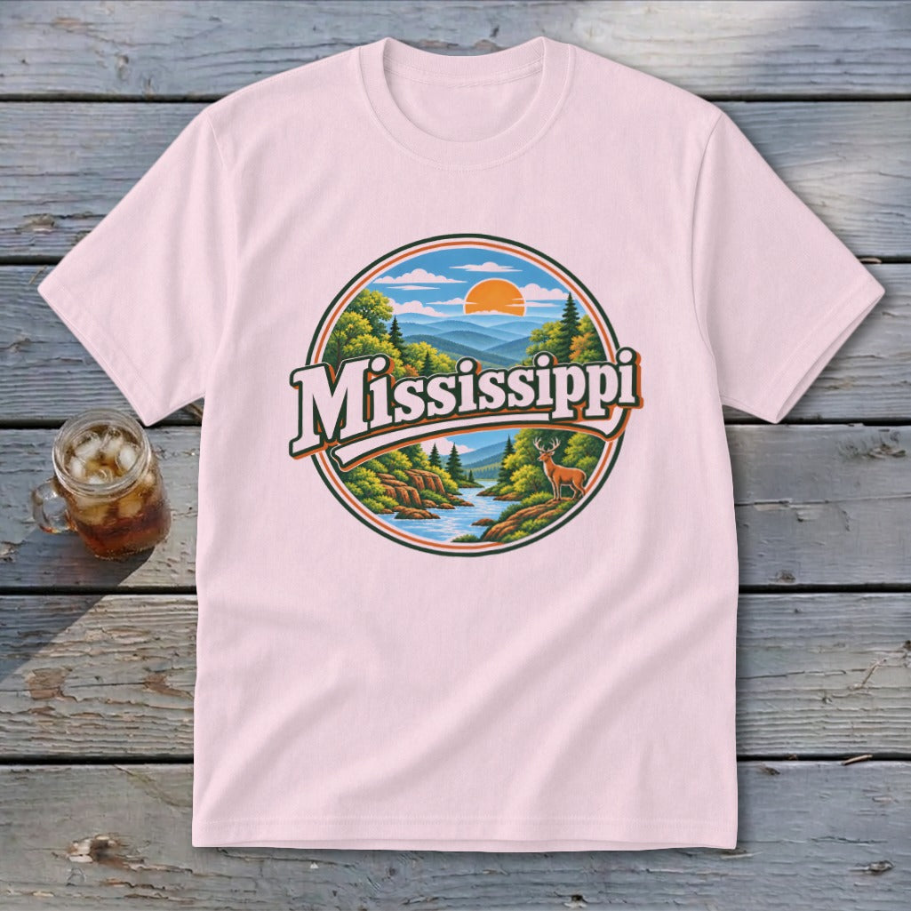 Pink t-shirt with a circular graphic of a river, mountains, and deer, with the word Mississippi.