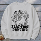 White sweatshirt with black graphic of three people flat-foot dancing and playing fiddle, text reads FLAT-FOOT DANCING.