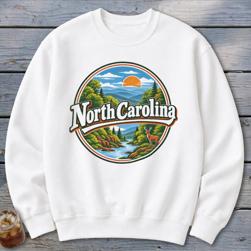 White sweatshirt with circular graphic featuring "North Carolina" text and a mountain landscape.