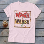 A light pink t-shirt with a vintage-style sign graphic that reads "WASH" crossed out in red and "WARSH" checked in green.