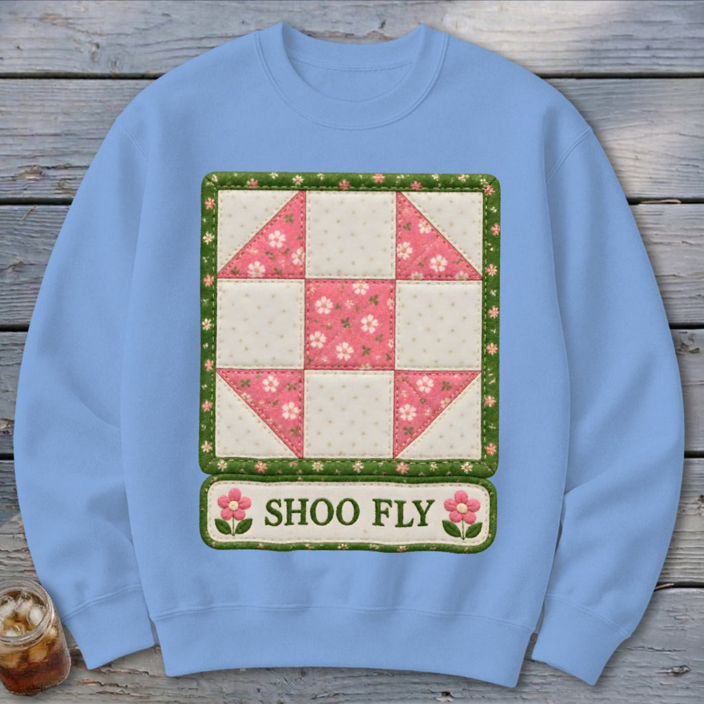 Light blue sweatshirt with a "Shoo Fly" quilt block design featuring pink floral squares.