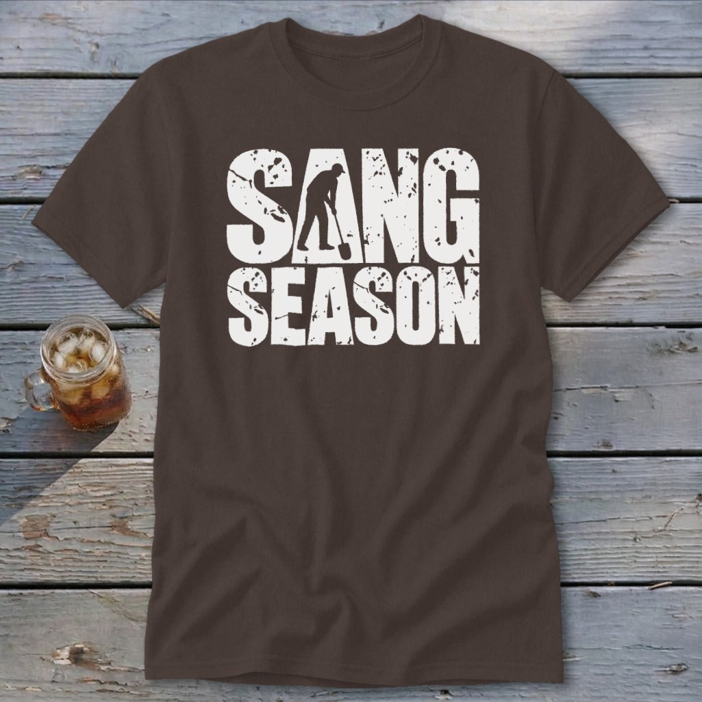 A brown t-shirt featuring white distressed text reading "SANG SEASON" with a silhouette of a person digging.