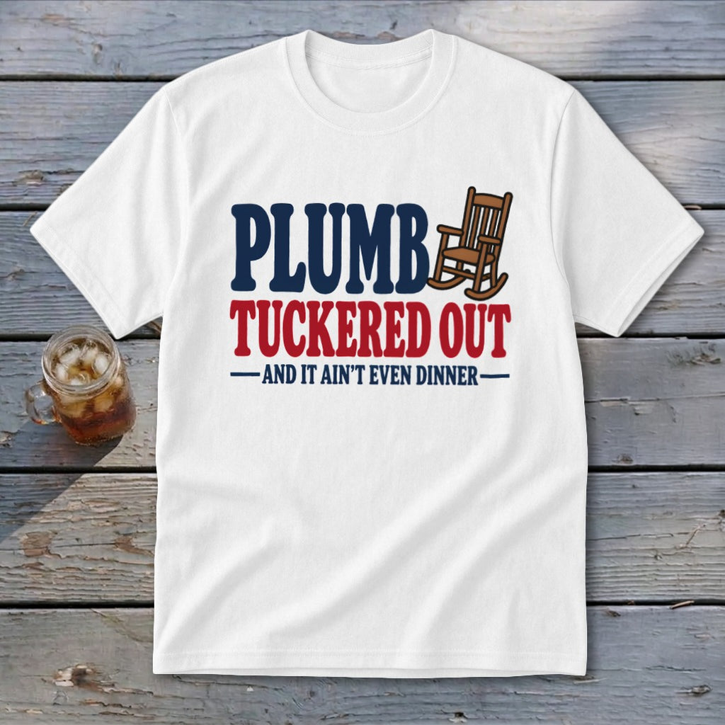 White t-shirt with "PLUMBE TUCKERED OUT AND IT AIN'T EVEN DINNER" text and rocking chair graphic.