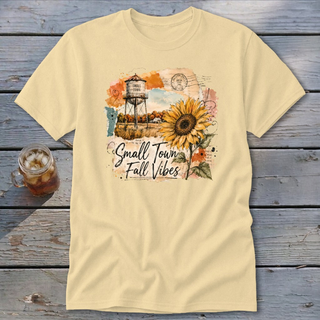 Yellow t-shirt with "Small Town Fall Vibes" text, water tower, and sunflower graphic.