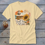 Yellow t-shirt with "Small Town Fall Vibes" text, water tower, and sunflower graphic.