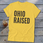 Yellow t-shirt with dark brown text reading "OHIO RAISED"