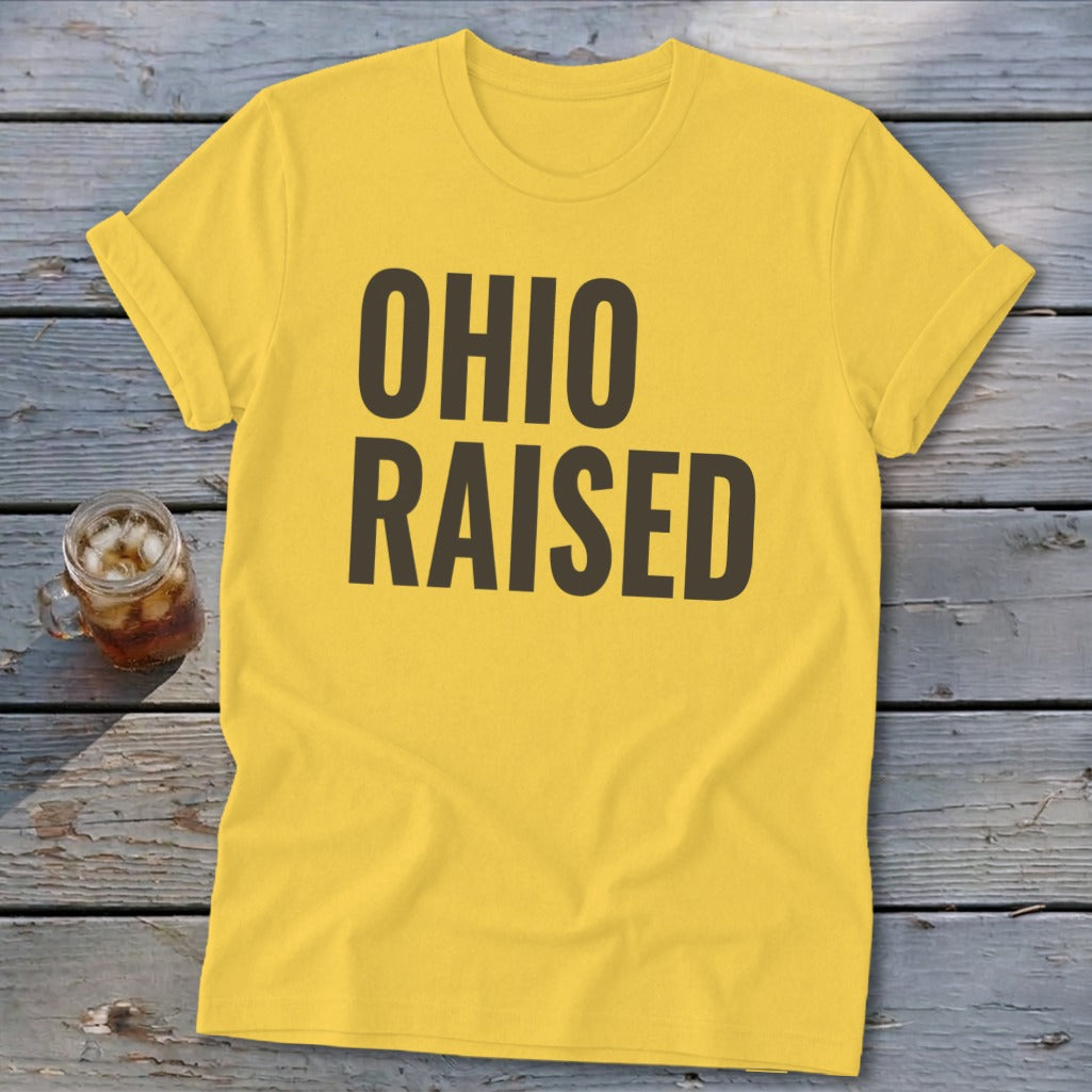 Yellow t-shirt with dark brown text reading "OHIO RAISED"