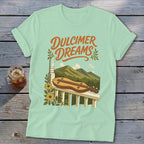 Light blue t-shirt with "Dulcimer Dreams" text and a dulcimer on a porch railing.
