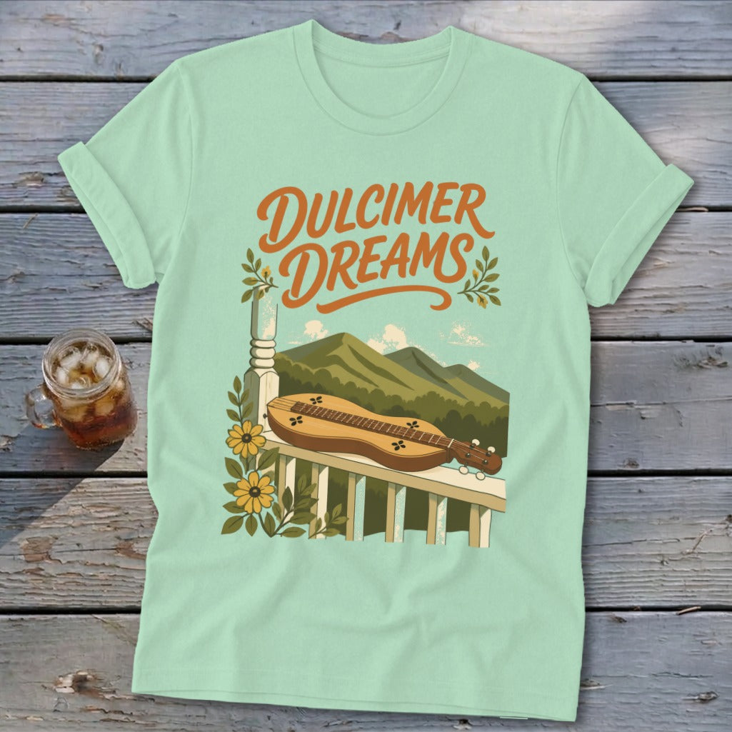Light blue t-shirt with "Dulcimer Dreams" text and a dulcimer on a porch railing.