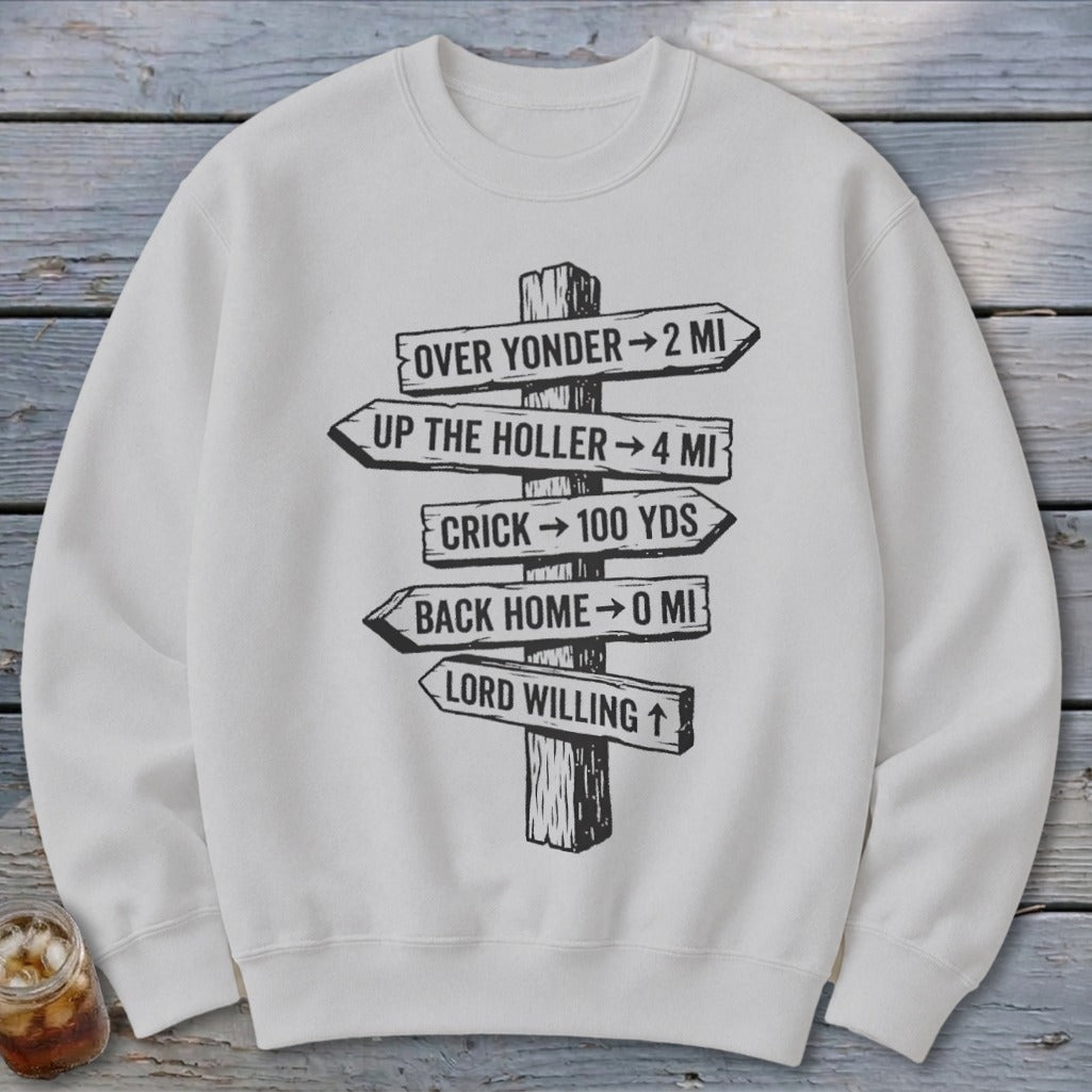 A light gray sweatshirt features a rustic wooden signpost graphic with humorous directional distances.