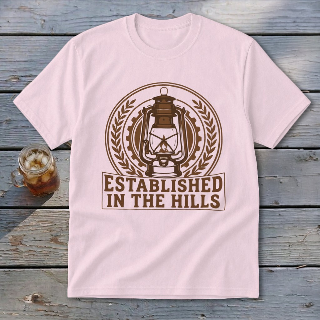 Pink t-shirt with "Established In The Hills" text and a lantern graphic.