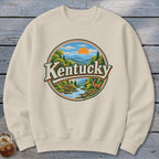 Cream sweatshirt with round vintage Kentucky landscape graphic and deer.