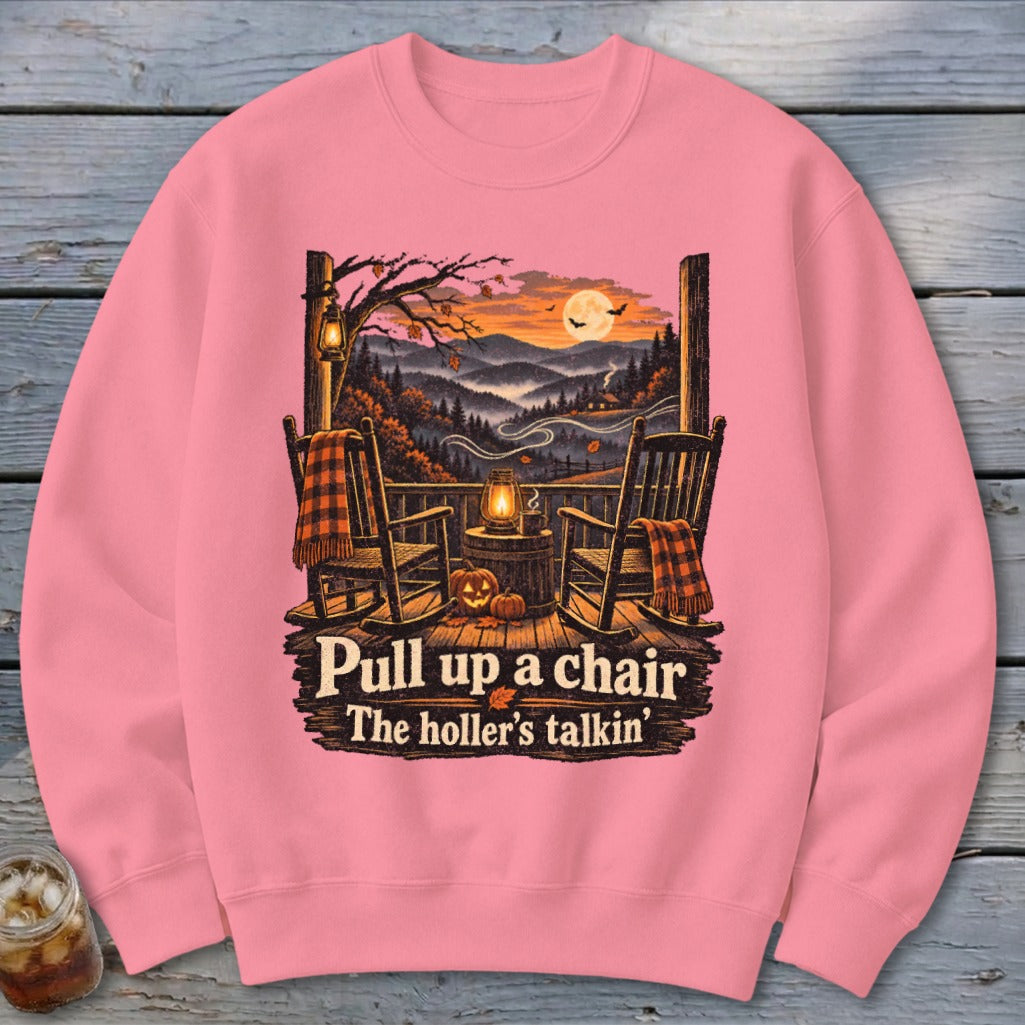 Pink sweatshirt with rocking chairs on a porch, autumnal landscape, and text.