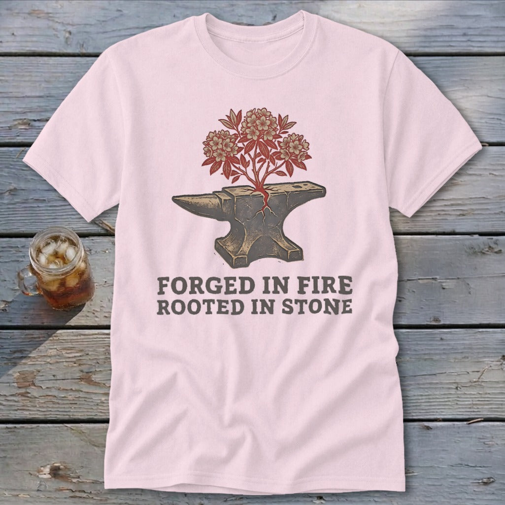 Pink t-shirt with anvil and flowering branches graphic and text "FORGED IN FIRE ROOTED IN STONE".