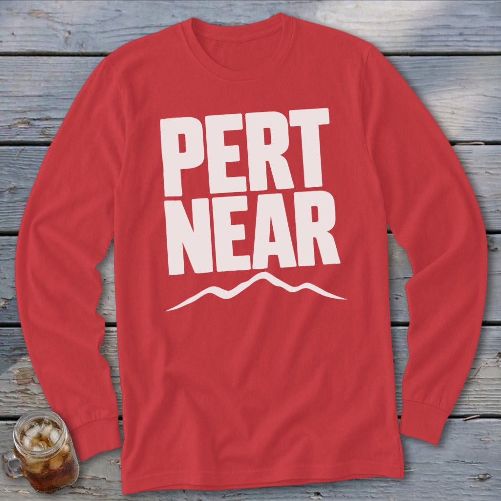 Red long-sleeved crewneck shirt with white text reading "PERT NEAR" above a mountain graphic.