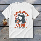 White t-shirt with a bear wearing a hat and drinking from a jar, with text "Porch Sittin' Club est. after supper".