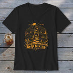 Black t-shirt with orange mountain, lantern, and "If you hear whistlin', keep hiking" graphic.