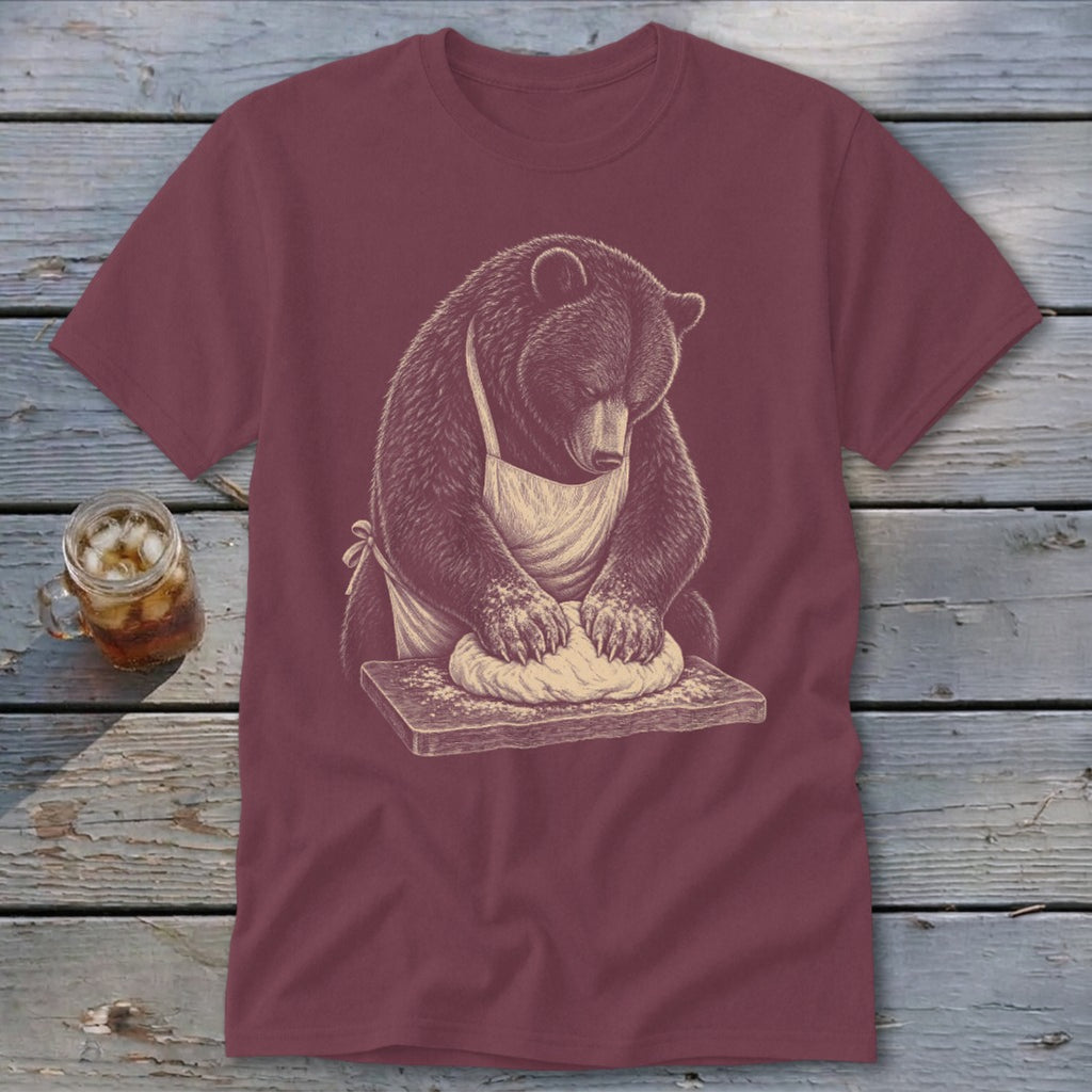 Bear wearing apron kneading dough on wooden board.