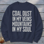 A dark blue crewneck sweatshirt with distressed white text reading Coal Dust in My Veins Mountains in My Soul.
