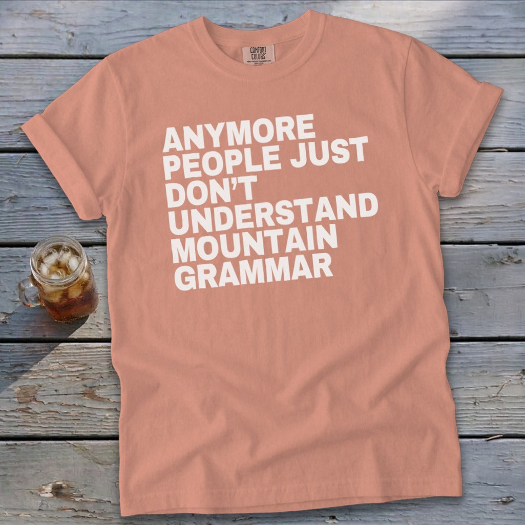 Peach t-shirt with white text: "Anymore people just don't understand mountain grammar."