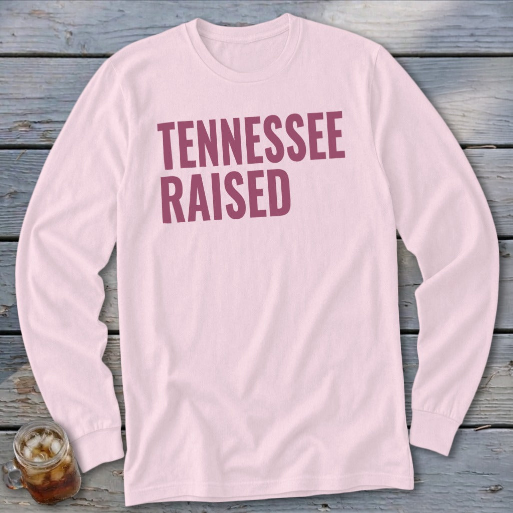 Pink long-sleeve shirt with "TENNESSEE RAISED" in maroon text.