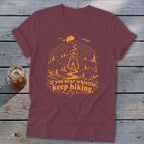 Maroon t-shirt with orange mountain graphic and "If you hear whistlin', keep hiking" text.