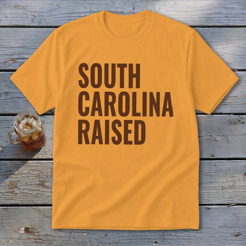 Orange t-shirt with brown text "SOUTH CAROLINA RAISED".