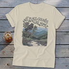 T-shirt with "No Place Sounds Like Home" text and bird in mountain landscape.