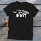 Black t-shirt with white text that reads "Colder Than A Welldigger's Boot."