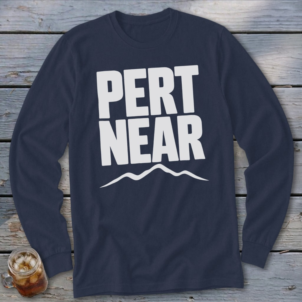 Dark blue long-sleeve crewneck t-shirt featuring the white text PERT NEAR above a mountain range graphic.