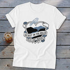 White t-shirt with heart graphic, bird, and text "Heart in the Holler Miles Can't Measure It".