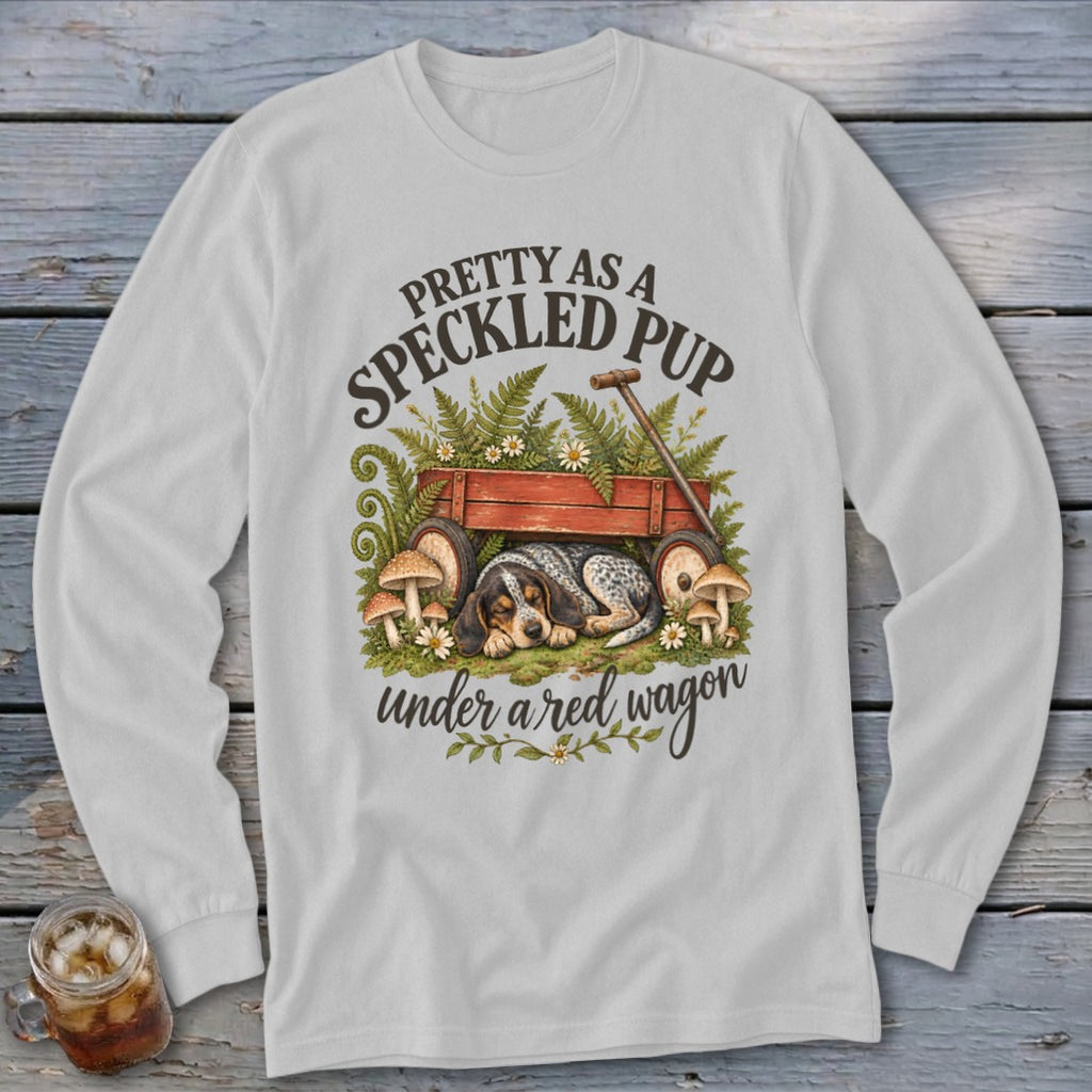 Long sleeve shirt with a speckled pup sleeping under a red wagon.