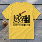 Yellow t-shirt with black graphic of stacked firewood and axe; text "STACKED FOR THE SEASON".