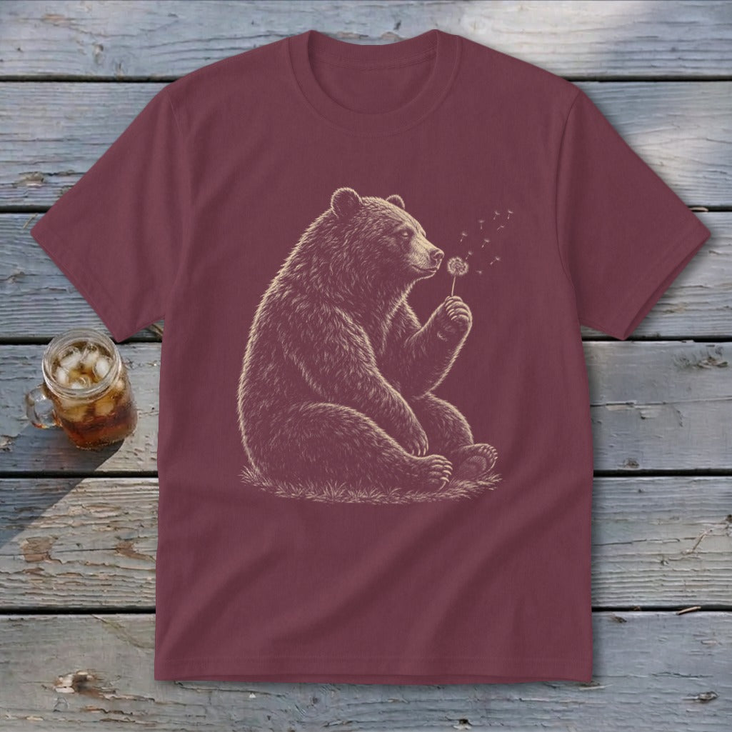 Maroon t-shirt with a sitting bear blowing dandelion seeds illustration.