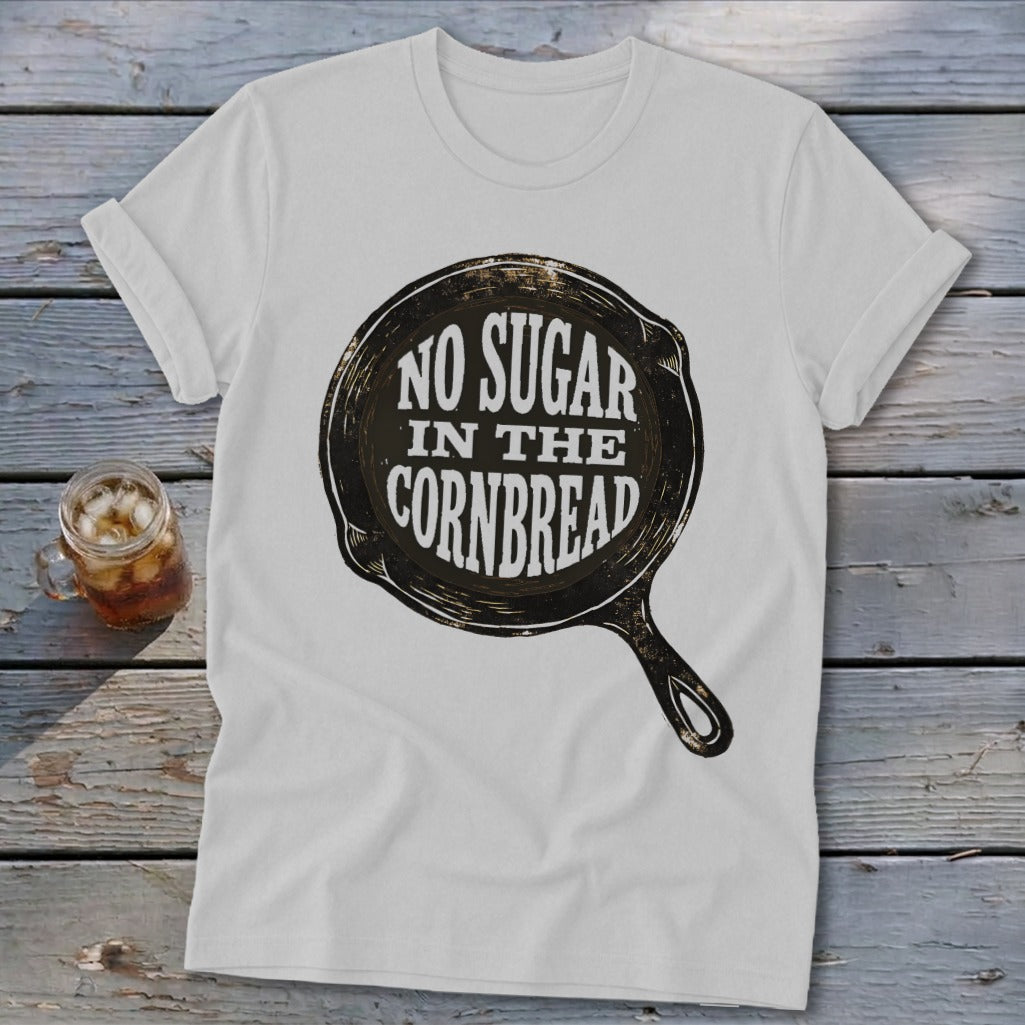 White t-shirt with "NO SUGAR IN THE CORNBREAD" text inside a cast iron skillet graphic.