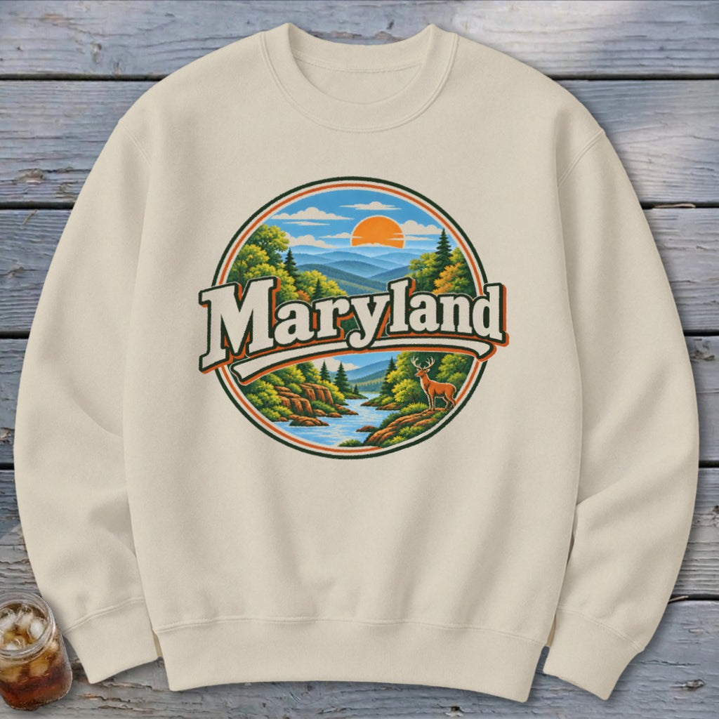 Crewneck sweatshirt with a circular Maryland nature graphic featuring mountains, a river, and a deer.