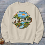 Crewneck sweatshirt with a circular Maryland nature graphic featuring mountains, a river, and a deer.