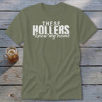 Olive green t-shirt with white text "THESE HOLLERS know my name".