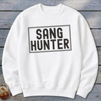White sweatshirt with black text "SANG HUNTER" inside a black rectangle.