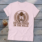Pink t-shirt with a vintage lantern graphic and text "Established in the Hills."