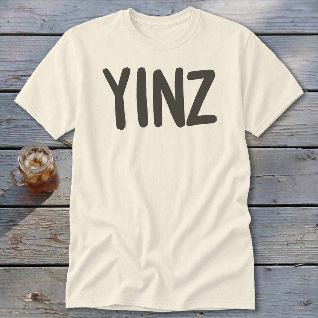 Cream t-shirt with dark gray "YINZ" text and a glass of iced tea.