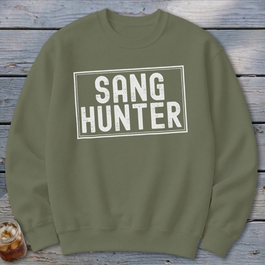 Olive green sweatshirt with white text reading "SANG HUNTER" inside a rectangle.