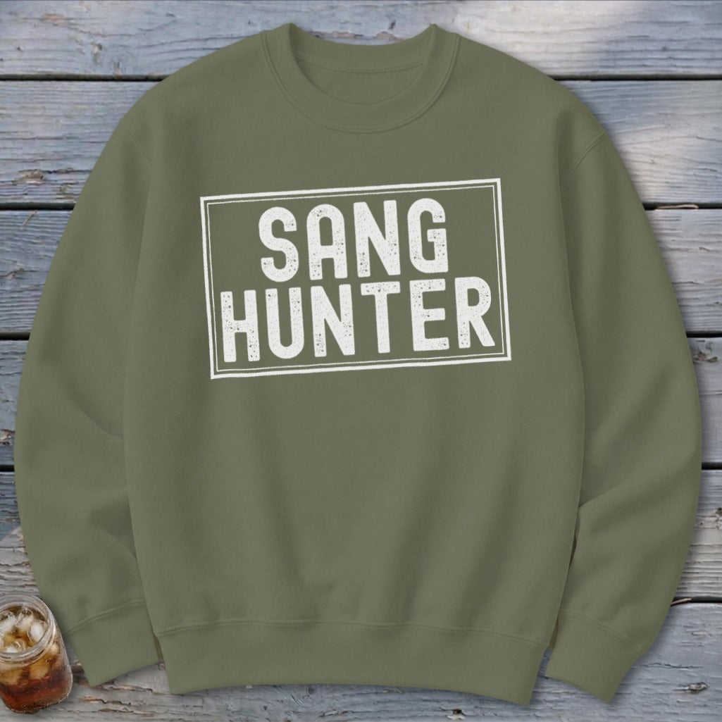 Olive green sweatshirt with white text reading "SANG HUNTER" inside a rectangle.