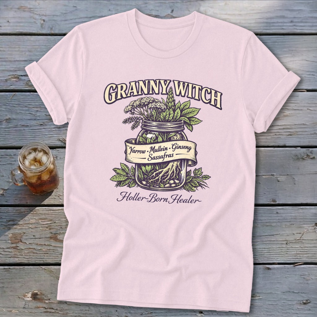 Pink t-shirt with "Granny Witch Holler-Born Healer" and a jar of herbs: Yarrow, Mullein, Ginseng, Sassafras.